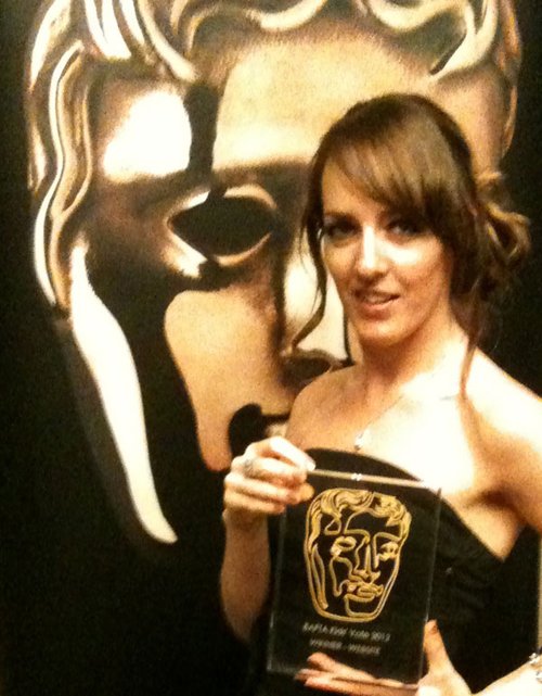 Portrait of Allie Crawford holding a BAFTA award